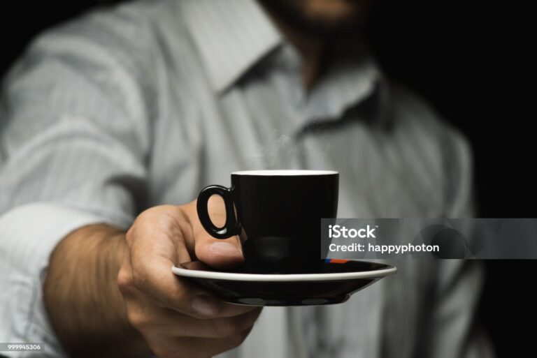 A man is holding a mug of coffee. Italian style