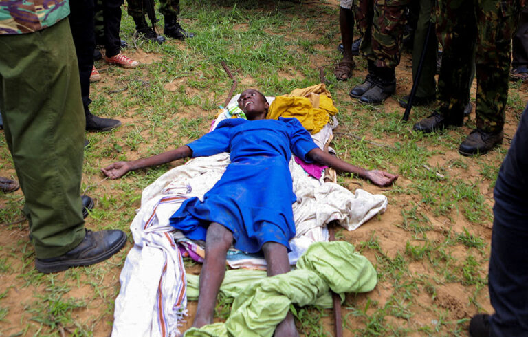 Kenya police officers and officials from the civil society rescue an emaciated member of a Christian cult in Kilifi